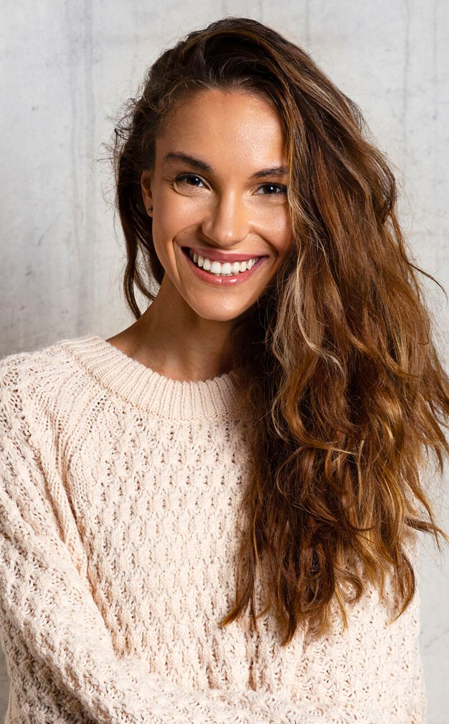 woman smiling in a sweater