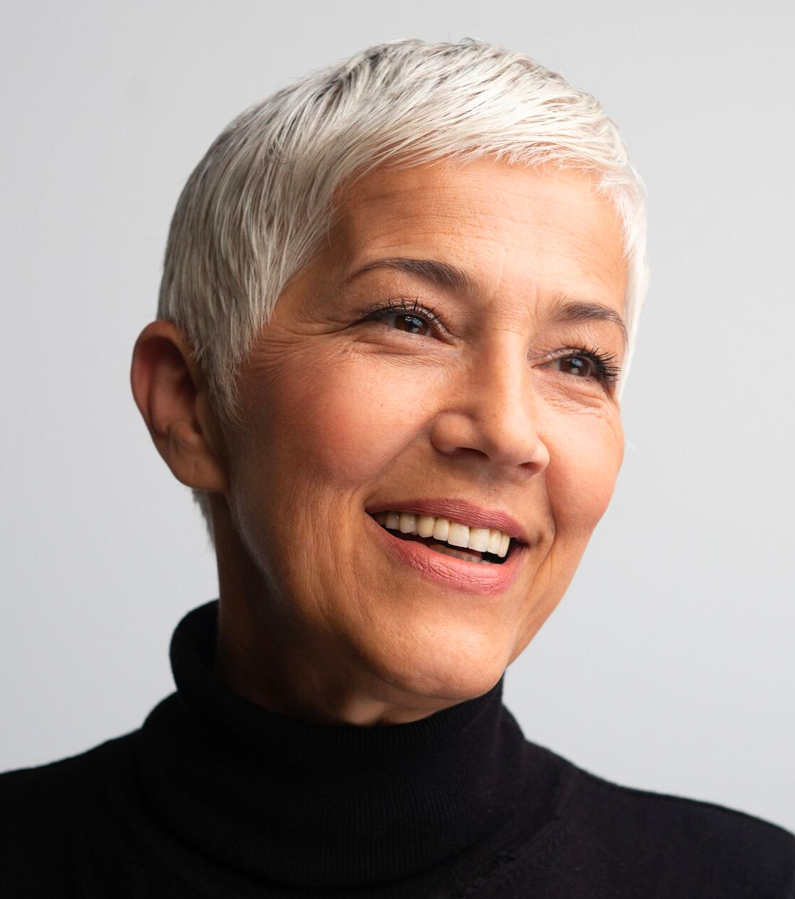 older woman with short hair smiling
