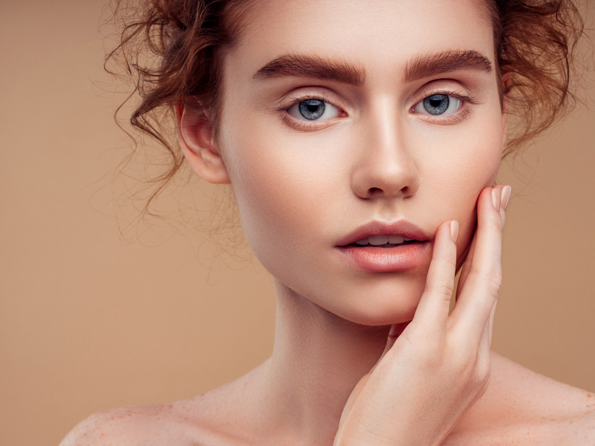 woman with cream on cheek