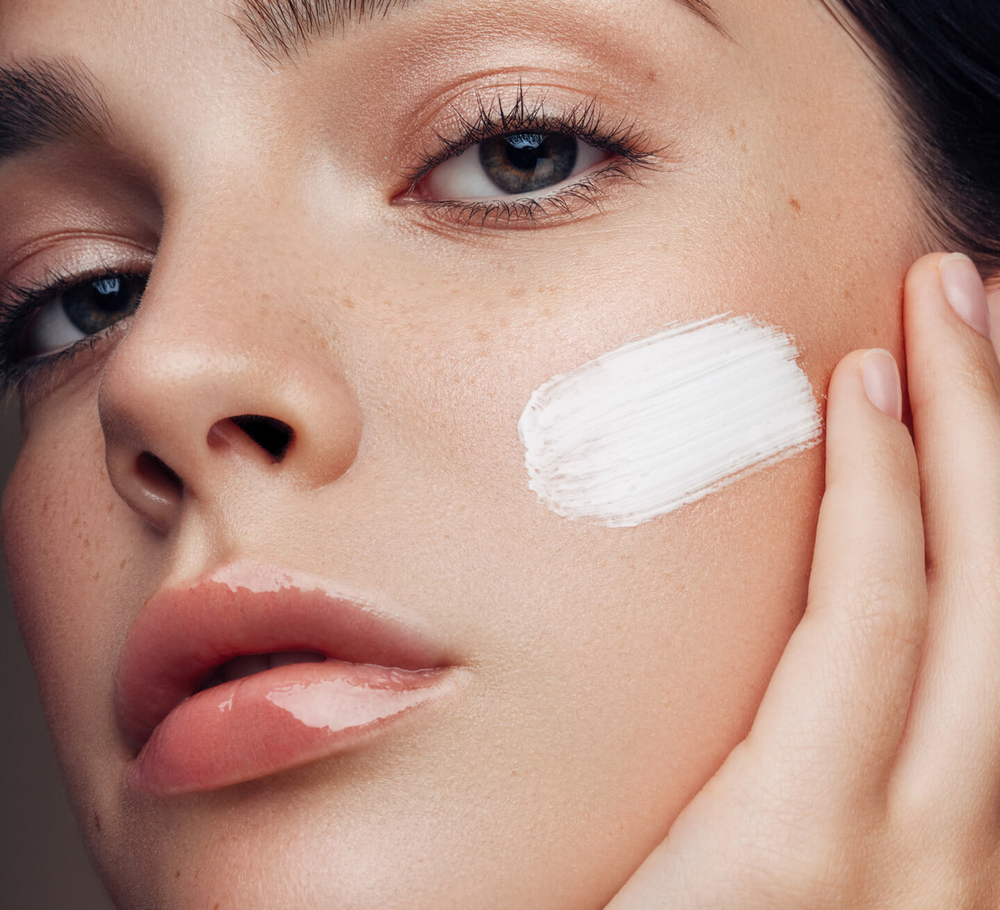 woman with cream on cheek