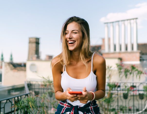 woman smiling on a rooftop terrace