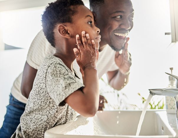 father and son washing their face