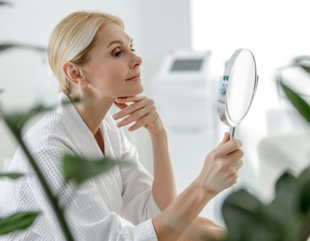 Middle aged woman looking in a mirror